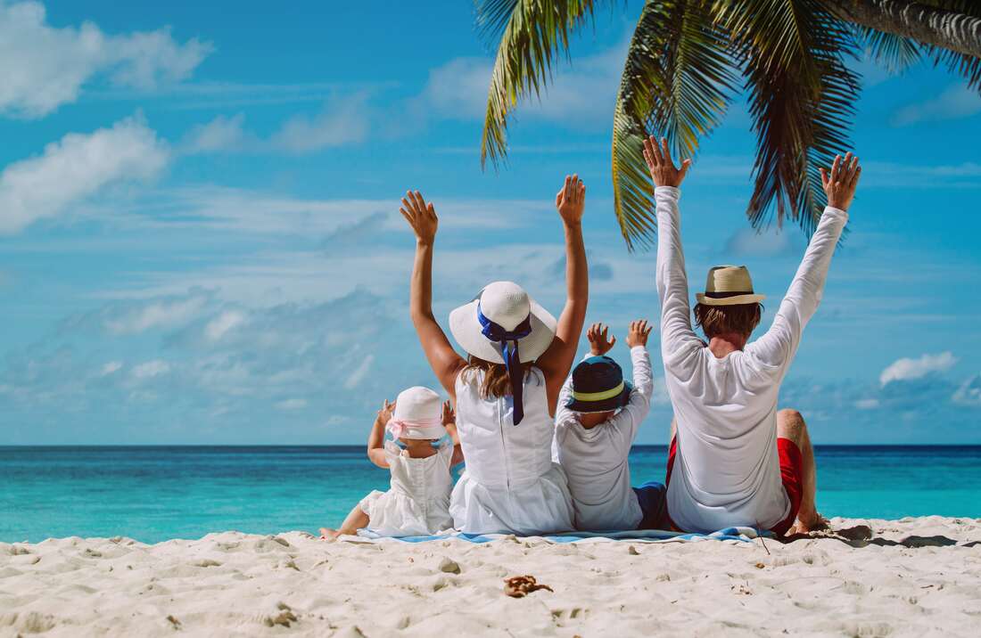 Family having fun at tropical resort beach front access.